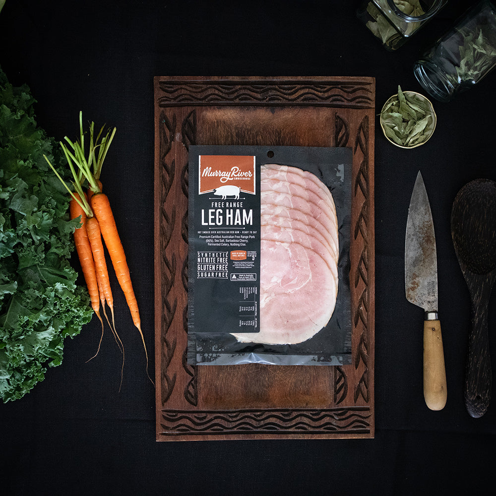 Sliced smoked leg ham on a board